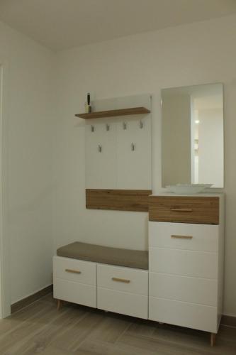 a dressing room with a bench and a mirror at Zemun Residence in Belgrade