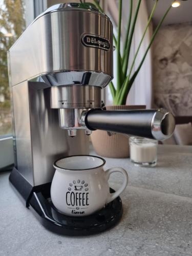 a coffee maker sitting on a counter with a cup at Apartament Coffee Time in Tarnów