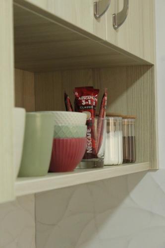 a shelf with bowls and other kitchen items on it at Zemun Residence in Belgrade