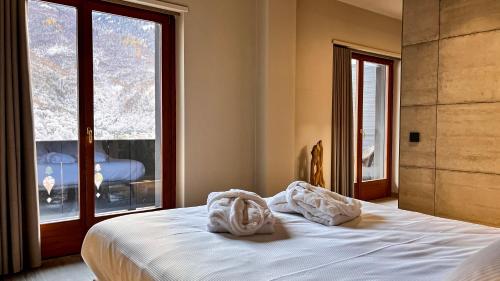 Postel nebo postele na pokoji v ubytování Agarthi Suites - Valtellina