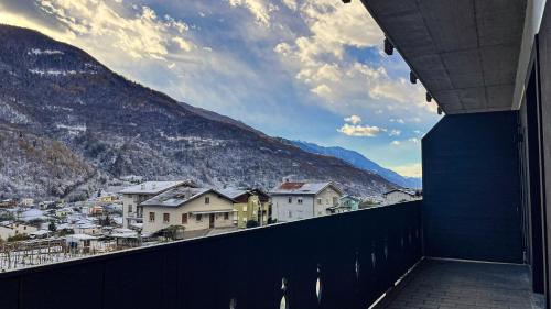 a balcony with a view of a town and mountains at Agarthi Suites - Valtellina in Piateda