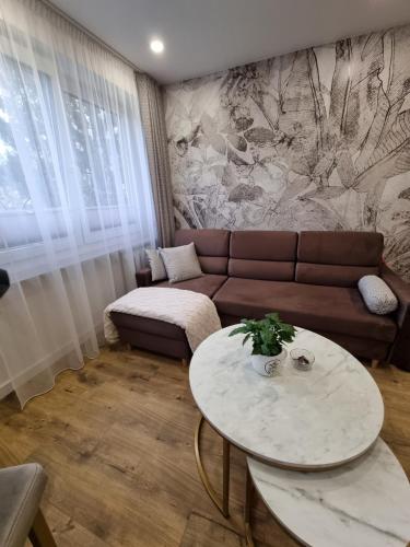 a living room with a couch and a table at Apartament Coffee Time in Tarnów