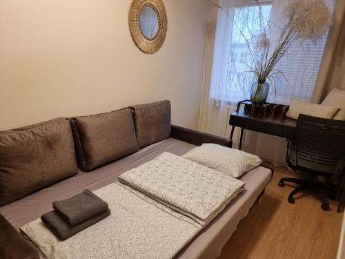 a couch in a living room with a table at Apartament Coffee Time in Tarnów
