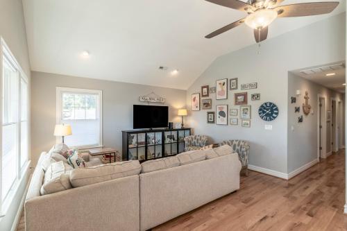a living room with a couch and a ceiling fan at OBX Beach Gnome in Kill Devil Hills