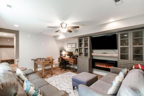 a living room with a couch and a flat screen tv at OBX Beach Gnome in Kill Devil Hills