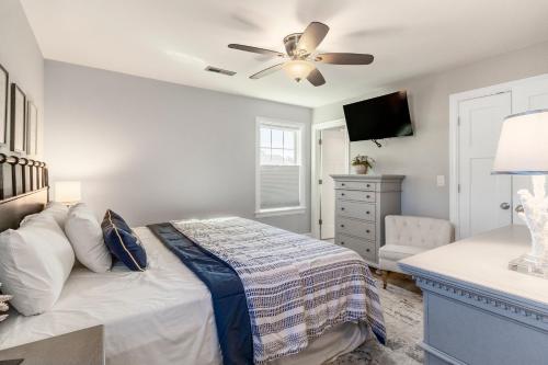 a bedroom with a bed and a ceiling fan at OBX Beach Gnome in Kill Devil Hills
