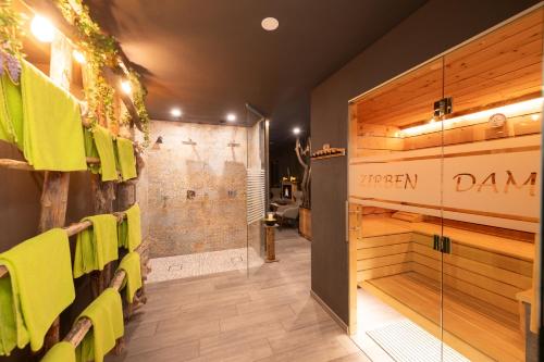 a bathroom with yellow chairs and a glass door at Landhotel Anna in Sankt Martin am Tennengebirge