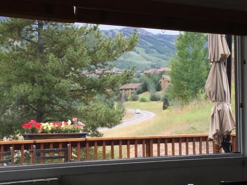a window of a balcony with a view of a road at Family & Friends Holiday House in Snowmass Village