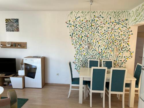 a dining room with a table and some chairs at Ana’s 2 bedrooms lovely flat in Podgorica