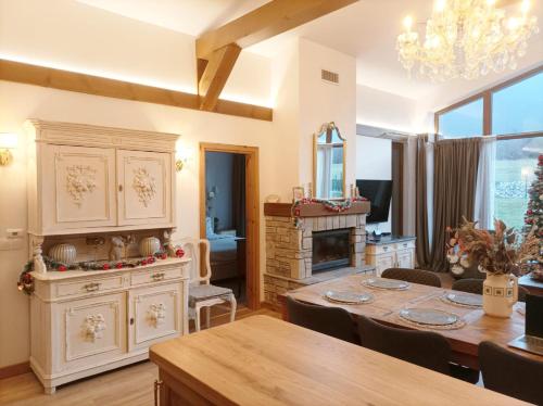 a dining room with a table and a fireplace at Villa Eliyas with Jacuzzi near the Pirin Golf Resort in Razlog