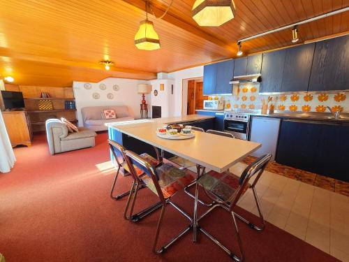 a kitchen with a table and chairs in a room at Le Vette di Moena - Alpine Stay Apartments in Moena