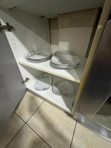 a cupboard with plates and dishes in it at M&G centar grada in Požarevac