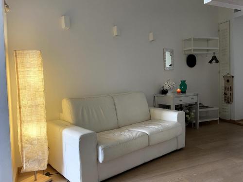 a living room with a white couch and a table at Baia delle Muse - Seaview Haven in Molfetta