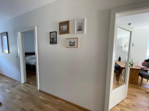 a room with a white wall and a mirror at Albarosa Appartemant in Öblarn