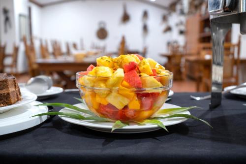 a bowl of fruit on a plate on a table at Masindi Hotel in Masindi