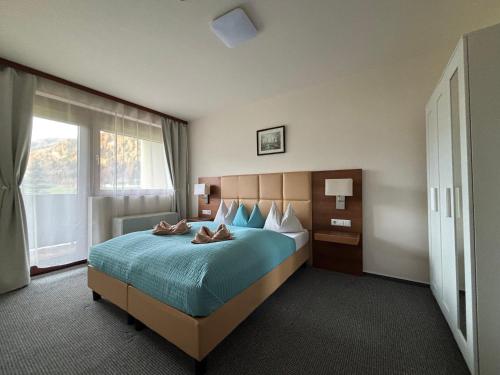 a hotel room with a bed with shoes on it at Ski Vital Apartments in Sankt Michael im Lungau