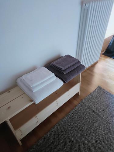 a wooden bunk bed with towels on top of it at Casa del ruscello in Mezzana