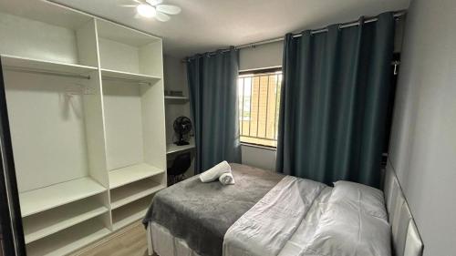 a bedroom with a bed and a window at Kit 102 Brasília in Brasilia