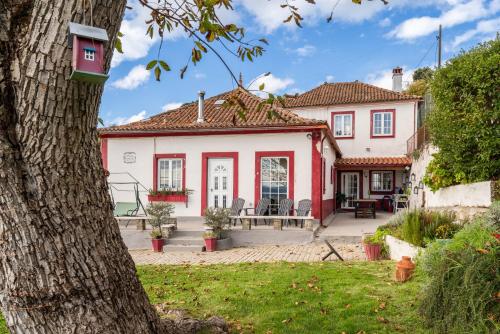a house with a red and white house at Casa da Fraga in Santa Marta de Penaguião