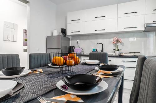 a kitchen with a table with black bowls on it at MarGio Bay in Limenas