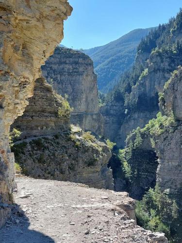 a view of a canyon with a dirt road at Mini chalet dans le Mercantour in Colmars