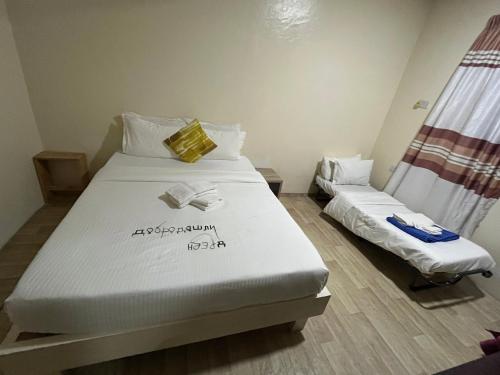 a bedroom with two beds in a room at Konut by Thakuru in Guraidhoo