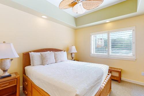 a bedroom with a bed and a window at Kahalu'u Beach Villas 1-203 in Kailua-Kona