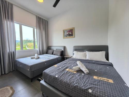 Ένα ή περισσότερα κρεβάτια σε δωμάτιο στο Langkawi Simfoni Cassia Suite 07 8pax