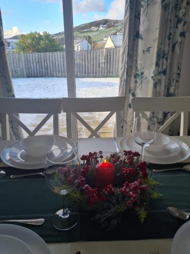 a table with a candle and glasses on a table at Beach Park House in Downings