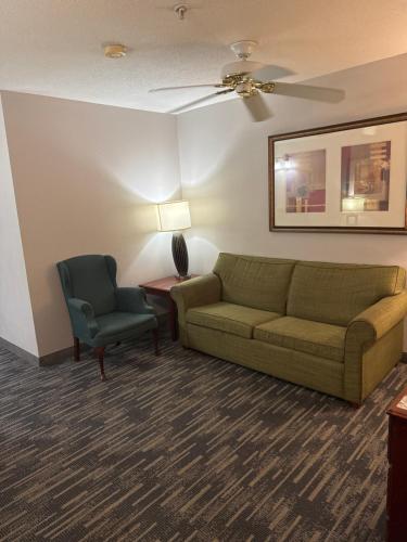 a living room with a couch and a chair at Country Inn & Suites by Radisson, Elgin, IL in Elgin