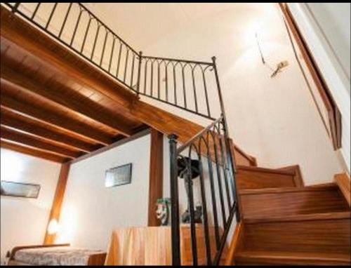 a staircase in a home with a wooden stair case at blue terrace Amalfi in Atrani