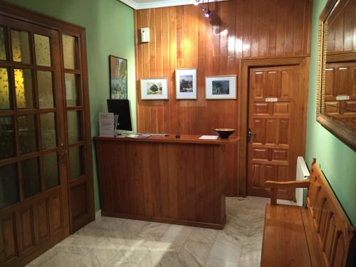 a hallway with a wooden door and a counter at El Cardeo in La Revilla