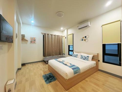 a bedroom with a bed and a flat screen tv at DelZiaNa Bara Villa Pakbara Satun พักได้ 6 ท่าน in Satun