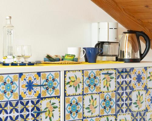 a kitchen counter with colorful tiles on a counter top at Hotel La Rondinella in Cannero Riviera
