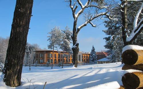 a building in the snow with snow covered trees at Hotel Zochova Chata - Adult friendly in Modra