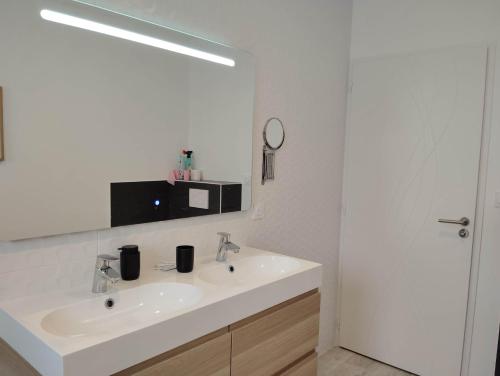 une salle de bain blanche avec un lavabo et un miroir dans l'établissement MAISON 3 chbres 3 étoiles St Gilles X de Vie, à Saint-Gilles-Croix-de-Vie