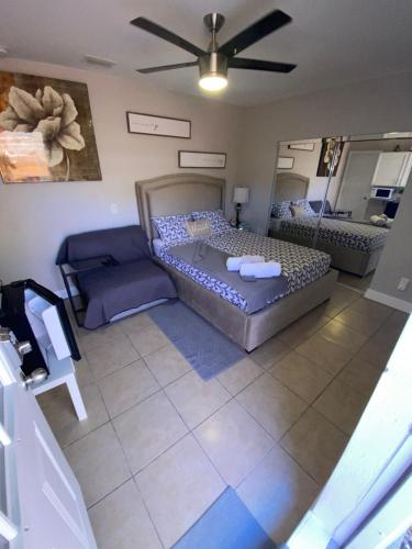 a large room with a bed and a couch at LUXURIOUS COZY STUDIO. in Tampa