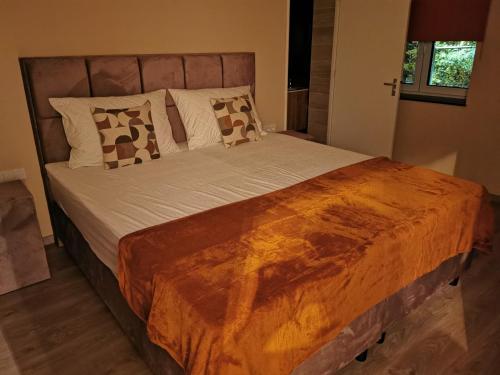 a bedroom with a large bed with white sheets and pillows at Hotel Parkzicht in Valkenburg