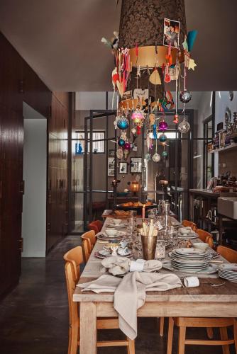 a long table with chairs and plates on it at Private room in Design House near Amsterdam in Halfweg
