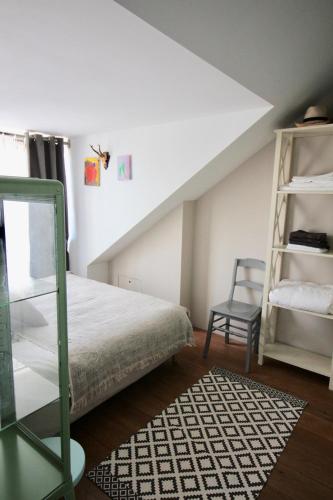 a bedroom with a bed and a ladder and a chair at Private room in Design House near Amsterdam in Halfweg