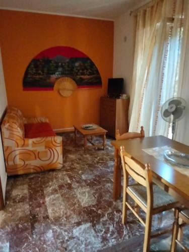 a living room with a table and a couch at Appartamento Ficarra Via Logge 16 in Ficarra