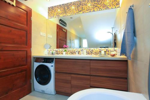 a bathroom with a washing machine and a mirror at Paskal-Lux Apartments with Free Parking and AC in Budapest