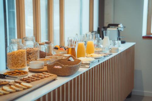 a buffet line with different types of food on it at La Maison Gaïa Hôtel & Spa in Torreilles