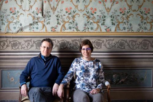 a man and a woman sitting on a bench at Il Castello di San Michele in San Michele in Teverina