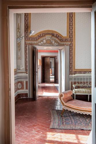 a living room with a couch and a mirror at Il Castello di San Michele in San Michele in Teverina