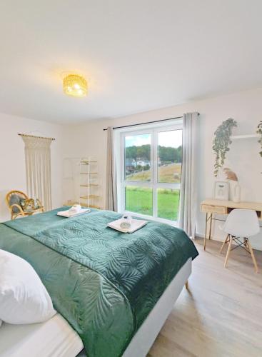 a bedroom with a large bed and a window at INIKAMA - Elegantes Apartment in Rosengarten