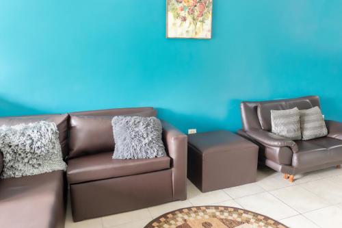 a living room with a couch and a chair at leroy place in Kingston
