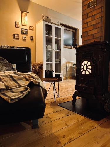 a living room with a wood stove in a room at Park Wilkasy in Gołdap