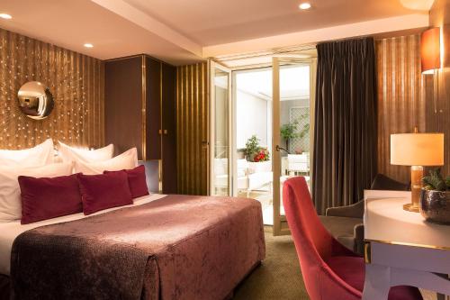 Letto o letti in una camera di Hôtel Baume