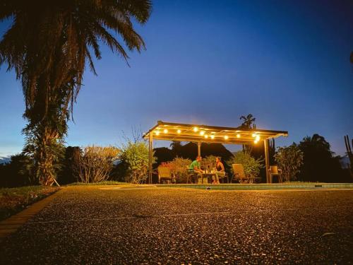 a group of people sitting under a gazebo with lights at Finca Hotel in Armenia